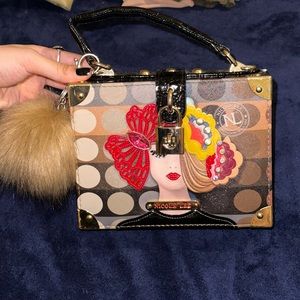 This was a gift to me from about 2 years ago. New Nicole Lee mini purse.